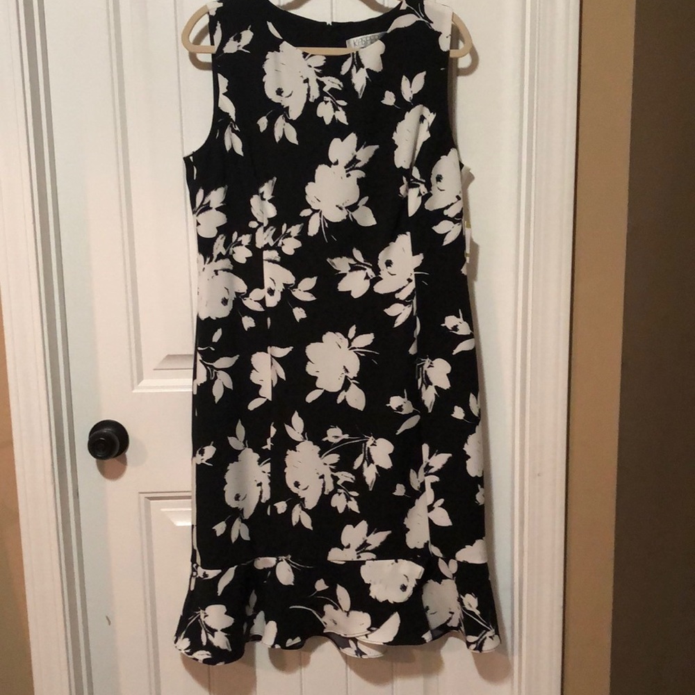 Kasper sleeveless sheath dress with ruffle hem; black with vanilla flowers;